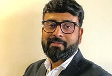 Confident man with glasses in formal suit for professional profile.